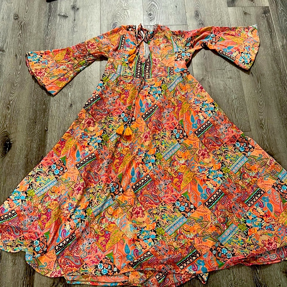 Worn once maxi dress bought in Greece. Tassels in back. Fits S-M.